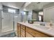Bathroom featuring a double sink vanity with a glass-enclosed shower and a window at 2928 Sunday Silence Rd, North Las Vegas, NV 89086