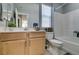 Bathroom with wood vanity, toilet, and shower/tub combo at 2928 Sunday Silence Rd, North Las Vegas, NV 89086