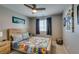 Comfortable bedroom with ceiling fan, wood-frame bed, and matching nightstands at 2928 Sunday Silence Rd, North Las Vegas, NV 89086
