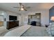 Bedroom features an office workspace, a ceiling fan, and TV on a dresser next to the bathroom at 2928 Sunday Silence Rd, North Las Vegas, NV 89086