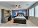 Bedroom features an office workspace, a ceiling fan, and a bed with nightstands at 2928 Sunday Silence Rd, North Las Vegas, NV 89086