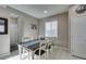 Bright dining room featuring a large table and ample natural light from a large window at 2928 Sunday Silence Rd, North Las Vegas, NV 89086