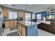 Open kitchen with stainless steel appliances, granite counters, and large island flowing into a comfortable living space at 2928 Sunday Silence Rd, North Las Vegas, NV 89086