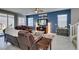 Comfortable living room with leather seating, a ceiling fan, and bright natural light at 2928 Sunday Silence Rd, North Las Vegas, NV 89086