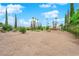 Large backyard with desert landscaping, mature trees, and plenty of space for outdoor activities at 3065 S Torrey Pines Dr, Las Vegas, NV 89146