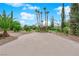 Large concrete pad in the backyard with desert landscaping and mature trees at 3065 S Torrey Pines Dr, Las Vegas, NV 89146