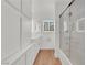 Modern bathroom featuring sleek white cabinetry, wood floors and a glass enclosed shower at 3065 S Torrey Pines Dr, Las Vegas, NV 89146