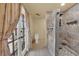 Bathroom with a tiled shower, toilet and french door leading to the outside at 3065 S Torrey Pines Dr, Las Vegas, NV 89146