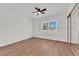 Bright bedroom with light wood floors, a ceiling fan, and sliding glass closet doors at 3065 S Torrey Pines Dr, Las Vegas, NV 89146