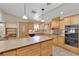 Bright kitchen features custom cabinetry, tile countertops, double ovens, and pendant lighting at 3065 S Torrey Pines Dr, Las Vegas, NV 89146