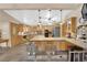 Spacious kitchen featuring an island with bar seating, wooden cabinetry, and modern appliances at 3065 S Torrey Pines Dr, Las Vegas, NV 89146