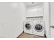Functional laundry room with modern washer and dryer, plus overhead storage cabinets at 3065 S Torrey Pines Dr, Las Vegas, NV 89146