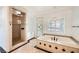 Luxurious bathroom featuring a soaking tub, a separate shower, and elegant tile work with mosaic accents at 3198 Stella Cilento Ave, Henderson, NV 89044