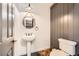 Stylish powder room features a pedestal sink, modern fixtures, and wood-look accents at 3198 Stella Cilento Ave, Henderson, NV 89044