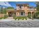 Stunning two-story home featuring lush landscaping, private driveway, and elegant stone accents at 3198 Stella Cilento Ave, Henderson, NV 89044