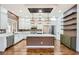 Spacious kitchen with custom cabinets, stainless steel appliances, and a center island with pendant lighting at 3198 Stella Cilento Ave, Henderson, NV 89044
