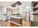 Modern kitchen featuring a large island, stainless steel appliances, and custom wood accents at 3198 Stella Cilento Ave, Henderson, NV 89044