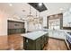 Bright kitchen boasts an island with bar seating and stainless appliances that flows into a living space at 3198 Stella Cilento Ave, Henderson, NV 89044