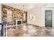 Cozy living room with a fireplace, decorative wood accent wall and stone floors at 3198 Stella Cilento Ave, Henderson, NV 89044