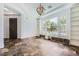 Open living room with built in cabinets and shelves featuring large windows and stone floors at 3198 Stella Cilento Ave, Henderson, NV 89044