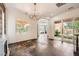 Open-concept living room with fireplace, chandelier, and sliding glass doors to the backyard at 3198 Stella Cilento Ave, Henderson, NV 89044