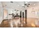 Spacious open-concept living area with kitchen, hardwood floors, ceiling fan, and modern lighting fixtures at 3198 Stella Cilento Ave, Henderson, NV 89044