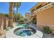 Backyard pool and jacuzzi combination, surrounded by lush landscaping and patio area at 3198 Stella Cilento Ave, Henderson, NV 89044