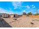 Large sand backyard featuring wood fencing and two outbuildings at 343 Tungsten St, Henderson, NV 89015