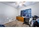 Cozy bedroom featuring a ceiling fan, a window with dark curtains and a dresser at 343 Tungsten St, Henderson, NV 89015