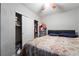 Modest bedroom shows sliding door closet and a queen bed with dark headboard at 343 Tungsten St, Henderson, NV 89015