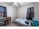 Bedroom with neutral walls, carpet, a bed frame and a desk near the windows at 343 Tungsten St, Henderson, NV 89015