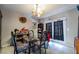 Bright dining room with tile flooring, chandelier, access to the exterior, and dark furniture at 343 Tungsten St, Henderson, NV 89015