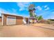 Single-story home featuring brown wood siding, front yard with desert landscaping, and a walkway to the front door at 343 Tungsten St, Henderson, NV 89015