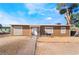Single-story home with brown wood siding, front yard with desert landscaping, and walkway to the front door at 343 Tungsten St, Henderson, NV 89015