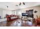 Living room featuring wood floors, comfortable seating, a large television, and a door to the exterior at 343 Tungsten St, Henderson, NV 89015