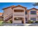 A two-story complex with a balcony and exterior staircase showcasing architectural details and inviting curb appeal at 350 S Durango Dr # 220, Las Vegas, NV 89145