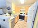 Efficient kitchen with tiled flooring and white appliances at 350 S Durango Dr # 220, Las Vegas, NV 89145