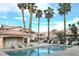 Community pool area with lounge chairs, palm trees, and well-maintained landscaping at 350 S Durango Dr # 220, Las Vegas, NV 89145