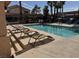 Relaxing pool area with tanning chairs and swaying palm trees, a perfect spot for residents to unwind and enjoy the sun at 350 S Durango Dr # 220, Las Vegas, NV 89145