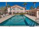 Beautiful pool reflecting the community buildings under a clear sky, offering a refreshing oasis for residents at 350 S Durango Dr # 220, Las Vegas, NV 89145