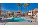 Full community pool view with lounge chairs and desert landscaping; enjoy the outdoor amenities of this complex at 350 S Durango Dr # 220, Las Vegas, NV 89145