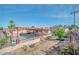 A view of the backyard patio, showing the covered area with a beautiful sky, flowers, and plants at 3558 Wayne Cir, Las Vegas, NV 89121