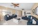 Open concept living area featuring ample seating, ceiling fans, and a view of the kitchen at 3558 Wayne Cir, Las Vegas, NV 89121