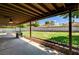 Relaxing covered back patio with a large green yard, perfect for outdoor activities at 3753 S Rosecrest Cir, Las Vegas, NV 89121