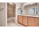 Bright bathroom with double vanity, wooden cabinets, and a shower-tub combo at 3753 S Rosecrest Cir, Las Vegas, NV 89121
