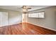 Spacious bedroom boasts wood-look flooring, large window, ceiling fan, and access to ensuite at 3753 S Rosecrest Cir, Las Vegas, NV 89121