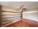 Bedroom with hardwood floors, closet shelving, ceiling fan, and neutral color walls at 3753 S Rosecrest Cir, Las Vegas, NV 89121