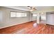 Bright bedroom featuring wood-look floors, a ceiling fan, and mirrored closet doors at 3753 S Rosecrest Cir, Las Vegas, NV 89121
