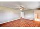 Bedroom with wood floors, neutral walls, ceiling fan, and ensuite access at 3753 S Rosecrest Cir, Las Vegas, NV 89121
