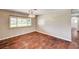 An empty dining room with light-colored walls, wood floors, a large window, and a chandelier at 3753 S Rosecrest Cir, Las Vegas, NV 89121